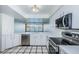 Bright kitchen featuring white cabinets, modern appliances, and a view of the water at 2775 Kipps Colony S Dr # 105, Gulfport, FL 33707