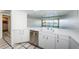 Kitchen featuring a stainless steel dishwasher, white countertops and cabinets, and a view at 2775 Kipps Colony S Dr # 105, Gulfport, FL 33707