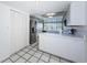 Clean kitchen featuring white cabinets, stainless steel appliances, and ample storage space at 2775 Kipps Colony S Dr # 105, Gulfport, FL 33707