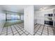 Well-lit kitchen with stainless steel appliances, white cabinets, and a view of the water at 2775 Kipps Colony S Dr # 105, Gulfport, FL 33707