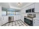 Updated kitchen with stainless steel appliances, white cabinets, and a view of the water at 2775 Kipps Colony S Dr # 105, Gulfport, FL 33707