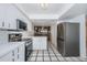 Well-equipped kitchen with stainless steel appliances, white cabinets, and access to the balcony at 2775 Kipps Colony S Dr # 105, Gulfport, FL 33707