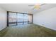 Bright living area with green carpet and large windows offering beautiful waterway views at 2775 Kipps Colony S Dr # 105, Gulfport, FL 33707