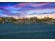 Scenic marina view with boats docked, set against a vibrant sunset sky and waterfront houses at 2775 Kipps Colony S Dr # 105, Gulfport, FL 33707