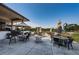 Inviting outdoor seating area with tables, umbrellas, and chairs, perfect for enjoying the beautiful weather and golf course views at 2775 Kipps Colony S Dr # 105, Gulfport, FL 33707