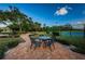 Outdoor seating area with brick patio, ornate table and chairs, and landscaped surroundings at 2775 Kipps Colony S Dr # 105, Gulfport, FL 33707
