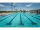 Large swimming pool with lap lanes and a smaller wading pool with seating areas and palm trees around the area at 2775 Kipps Colony S Dr # 105, Gulfport, FL 33707