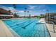 Large swimming pool with lap lanes, a smaller wading pool, and plenty of chairs and lounges for relaxing by the water at 2775 Kipps Colony S Dr # 105, Gulfport, FL 33707