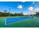 Well-maintained tennis courts with a blue and green surface, surrounded by trees at 2775 Kipps Colony S Dr # 105, Gulfport, FL 33707