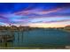 Expansive waterfront view showcasing a tranquil harbor with boat docks against a colorful twilight backdrop at 2775 Kipps Colony S Dr # 105, Gulfport, FL 33707