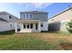 Backyard view features a covered patio and ample green space perfect for outdoor living at 28965 Orange Berry Dr, Wesley Chapel, FL 33543