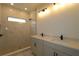 Bathroom boasts double sinks, modern lighting, and a walk-in shower with marble tile at 28965 Orange Berry Dr, Wesley Chapel, FL 33543
