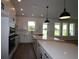 Bright kitchen featuring white cabinets, quartz countertops and modern stainless appliances at 28965 Orange Berry Dr, Wesley Chapel, FL 33543