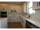 Modern kitchen featuring stainless steel appliances, sleek white cabinets and a sink with window at 28965 Orange Berry Dr, Wesley Chapel, FL 33543