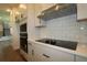 Modern kitchen features white cabinets, stylish backsplash, and stainless steel range hood at 28965 Orange Berry Dr, Wesley Chapel, FL 33543