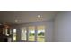 Bright living room with recessed lighting and scenic views through large windows at 28965 Orange Berry Dr, Wesley Chapel, FL 33543