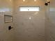 The walk-in shower features marble tile, a niche, and a sleek black shower head at 28965 Orange Berry Dr, Wesley Chapel, FL 33543