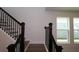 Staircase featuring dark wood railing, and oak-look stairs near the window at 28965 Orange Berry Dr, Wesley Chapel, FL 33543