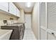 Practical laundry room with modern washer and dryer and ample storage at 3119 Blue Heron St, Safety Harbor, FL 34695