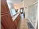 Bathroom featuring double sinks, tile flooring, and a glass-enclosed shower at 37544 Corey Lewis Ave, Zephyrhills, FL 33541