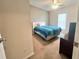 Bedroom featuring neutral carpet, ceiling fan, window and a double-size bed at 37544 Corey Lewis Ave, Zephyrhills, FL 33541