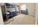 Cozy bedroom featuring a bunk bed, carpet flooring and a storage unit at 37544 Corey Lewis Ave, Zephyrhills, FL 33541