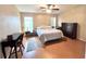 Comfortable bedroom with hardwood floors, desk and natural light at 37544 Corey Lewis Ave, Zephyrhills, FL 33541