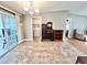 Open-concept dining area with tile flooring, chandelier, and slider access to the sunroom at 37544 Corey Lewis Ave, Zephyrhills, FL 33541