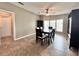 Spacious dining room with tile flooring, modern lighting, and large windows providing natural light at 37544 Corey Lewis Ave, Zephyrhills, FL 33541