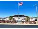 Community center exterior with flagpole and solar panels on roof at Grand Horizons community at 37544 Corey Lewis Ave, Zephyrhills, FL 33541