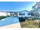 Charming single-story home featuring a carport, manicured lawn, and stone accents at 37544 Corey Lewis Ave, Zephyrhills, FL 33541