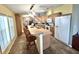 Open kitchen with an island, bar seating, stainless steel appliances, and tile floors at 37544 Corey Lewis Ave, Zephyrhills, FL 33541