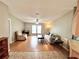 Open-concept living room with hardwood floors, ceiling fan, and lots of natural light at 37544 Corey Lewis Ave, Zephyrhills, FL 33541