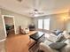 Comfortable living room with tile and hardwood floors, nice furniture and fan at 37544 Corey Lewis Ave, Zephyrhills, FL 33541