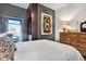 Cozy bedroom showcases a rustic wood dresser, large art piece, and a built in wardrobe at 777 N Ashley Dr # 1614, Tampa, FL 33602