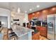 Open kitchen with granite island, stainless steel appliances, and warm wood cabinets at 777 N Ashley Dr # 1614, Tampa, FL 33602