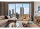 Bright living room features a large window showcasing city views and comfortable seating at 777 N Ashley Dr # 1614, Tampa, FL 33602