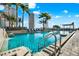 Rooftop pool boasts city views, lounge chairs, and tropical palm trees for relaxation and enjoyment at 777 N Ashley Dr # 1614, Tampa, FL 33602