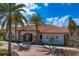 Attractive exterior view of the residence showcasing a paved entrance, palm trees and a tile roof at 8733 Sorano Villa Dr, Tampa, FL 33647