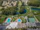 Stunning aerial view of the community's amenities, including pools, tennis courts, and a picturesque golf course at 9204 Golf View Dr, New Port Richey, FL 34655