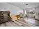 Cozy bedroom featuring hardwood floors, a loveseat, daybed and a dresser with ample natural light at 9204 Golf View Dr, New Port Richey, FL 34655