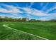 Expansive golf course view featuring lush greenery under a beautiful sky with golfers enjoying the course at 9204 Golf View Dr, New Port Richey, FL 34655