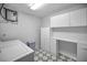 Spacious laundry room with washer, dryer, utility sink and ample cabinet space at 9204 Golf View Dr, New Port Richey, FL 34655