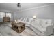 Bright living room featuring hardwood floors, a cozy white sofa set, and a decorative coffee table at 9204 Golf View Dr, New Port Richey, FL 34655