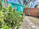Quaint backyard with lush greenery, stepping stones, and a privacy fence at 100 Waverly Way # 302, Clearwater, FL 33756