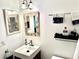 Well-lit bathroom features a modern sink, stylish fixtures, and a decorative mirror at 100 Waverly Way # 302, Clearwater, FL 33756