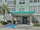 Building entrance featuring stone accents, covered entry, and handicap access at 100 Waverly Way # 302, Clearwater, FL 33756
