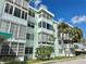 A well-maintained condo building with large windows and tropical landscaping at 100 Waverly Way # 302, Clearwater, FL 33756