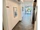 Hallway leading to entrance door with textured walls, tile floors, and an elevator at 100 Waverly Way # 302, Clearwater, FL 33756