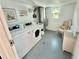Bright and clean laundry room featuring modern appliances and a cozy waiting area at 100 Waverly Way # 302, Clearwater, FL 33756